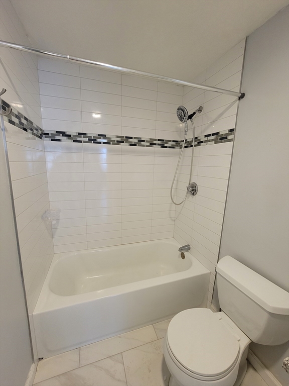 7 Gibbs Street, Unit 7 Worcester, MA 01607 - Photo 18 of 20 a bathroom with a shower a toilet and a bathtub