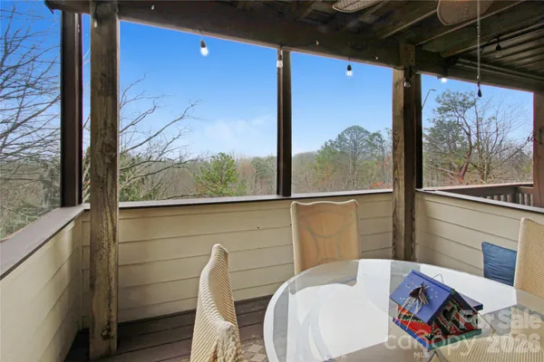 a balcony with furniture and a potted plant