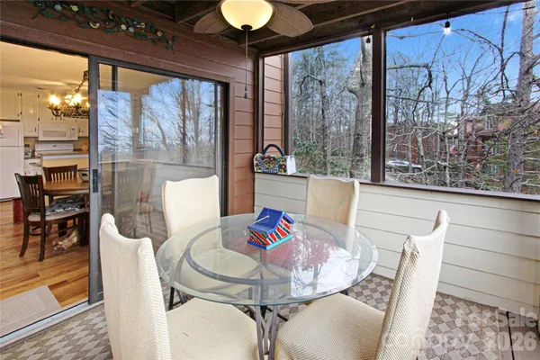 a dining room with furniture a chandelier and wooden floor