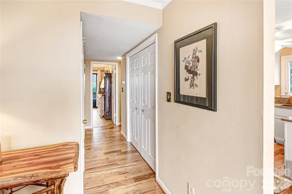 a view of a hallway with wooden floor and entryway