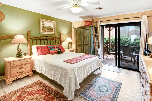 a bedroom with a bed and a large window