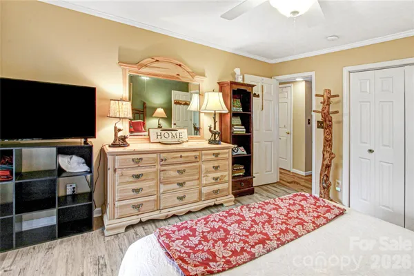 a bedroom with a bed and flat screen tv