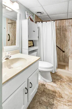 a bathroom with a sink toilet and shower