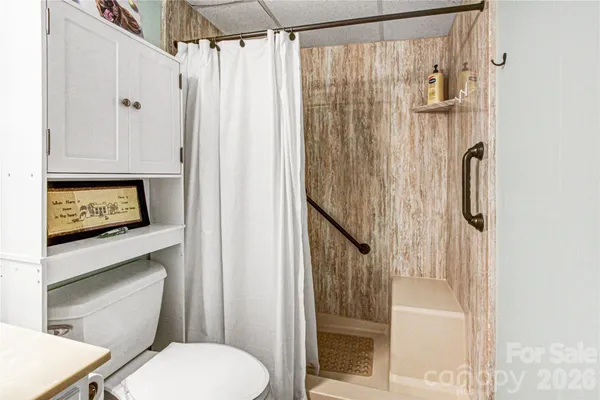 a bathroom with a toilet a sink and shower