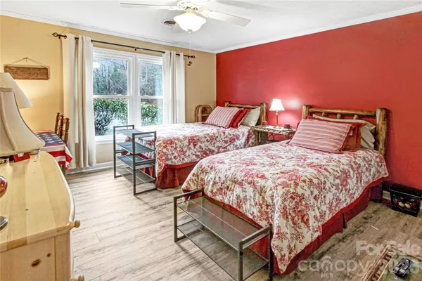 a bedroom with bed and wooden floor