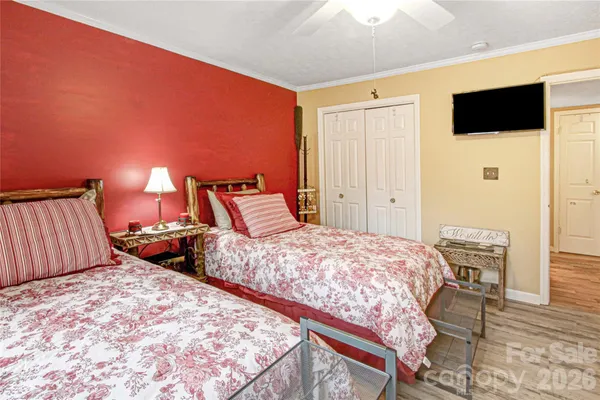 a bedroom with two beds and a flat screen tv