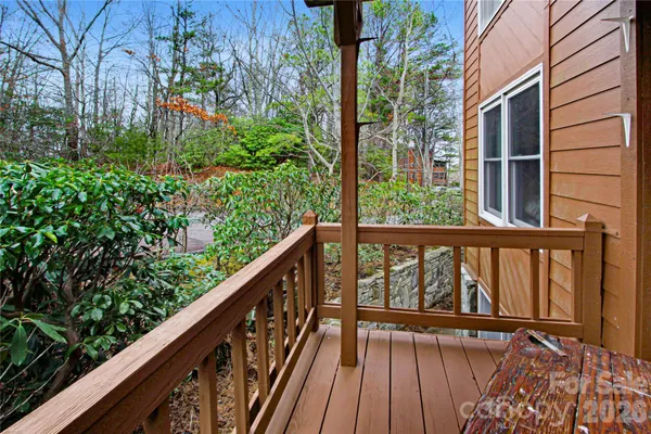 a view of balcony with wooden floor and fence