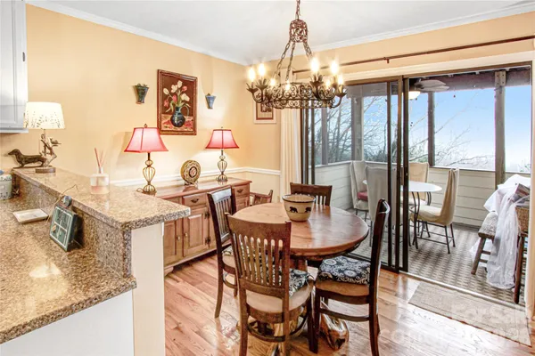 a view of a dining room with furniture and a chandelier
