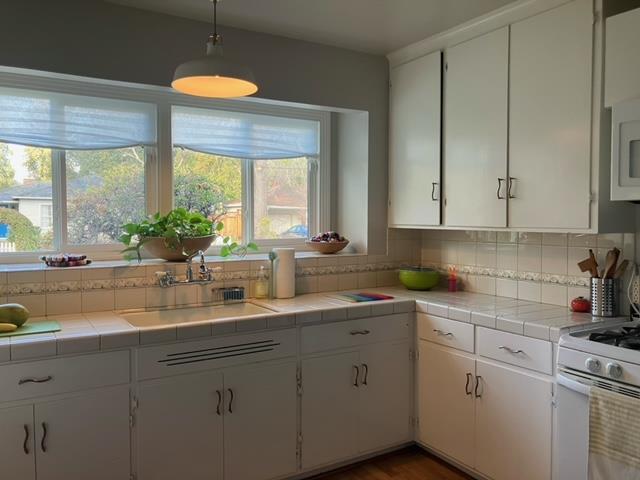 310 McKendry Drive Menlo Park, CA 94025 - Photo 5 of 14 a kitchen with stainless steel appliances white cabinets and a window