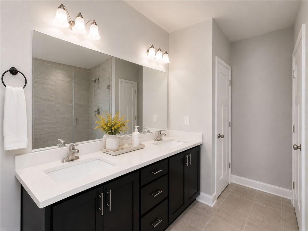 3359 Elkhorn Ridge Run Dacula, GA 30019 - Photo 28 of 35 a bathroom with a sink double vanity and a mirror