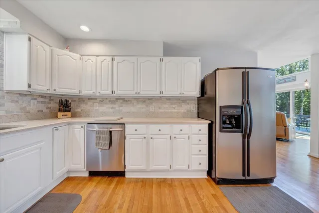 a bathroom with a granite countertop sink a toilet and shower
