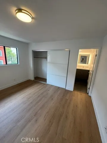 a view of a livingroom with wooden floor and a window