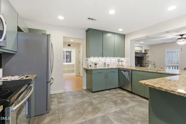 a view of a dining room with furniture and chandelier
