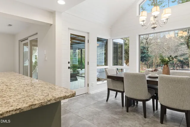 a work room with furniture and a large window
