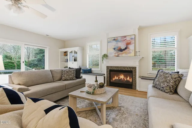 a couch sitting in a bedroom next to a window with potted plants