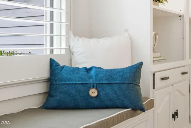 a bathroom with a granite countertop sink mirror and a window