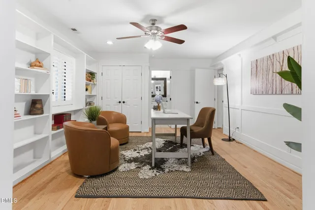 an empty room with ceiling fan and window