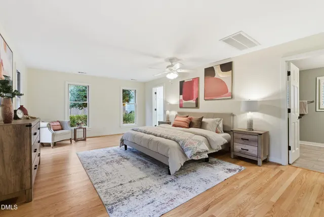 a bathroom with a toilet a sink a vanity and mirror