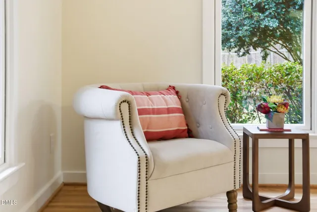 a living room with furniture and a floor to ceiling window