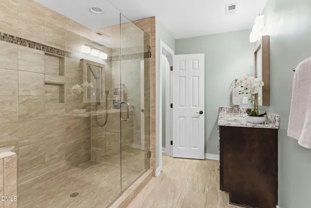 a view of backyard with plants and large trees