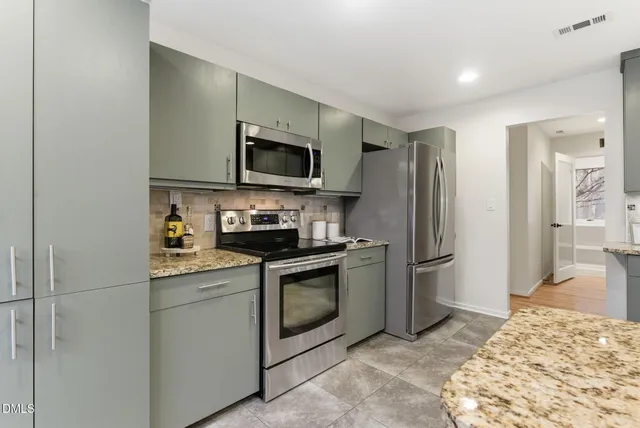 a kitchen with a table and chairs in it