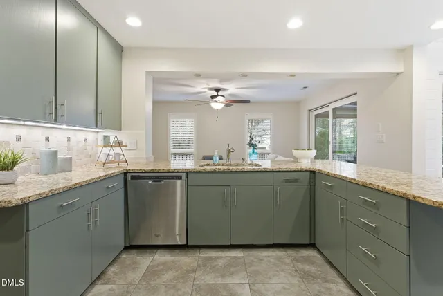 a kitchen with kitchen island a sink stainless steel appliances and cabinets