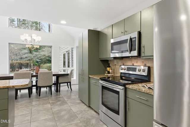 a view of a dining room with furniture wooden floor and chandelier