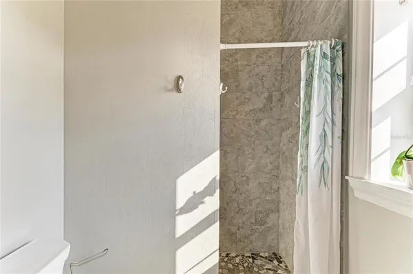 a bathroom with a sink mirror and window