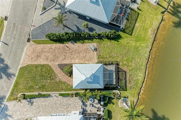 an aerial view of residential houses with outdoor space and swimming pool