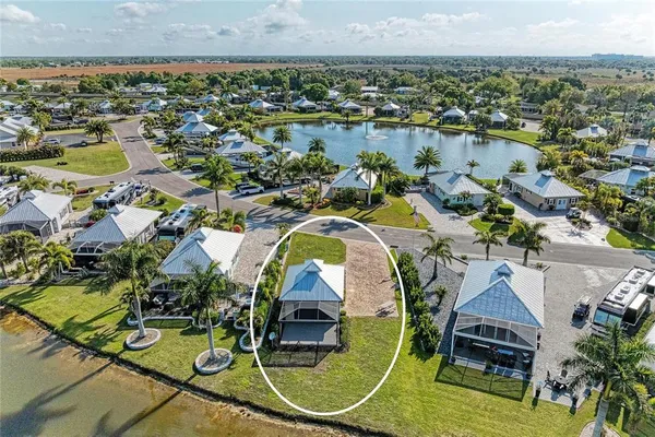 an aerial view of a house with a lake view
