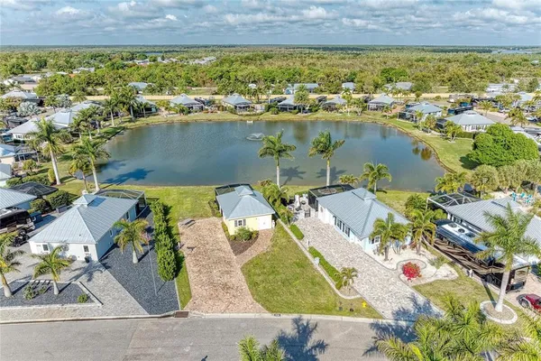 an aerial view of a house with swimming pool and lake view
