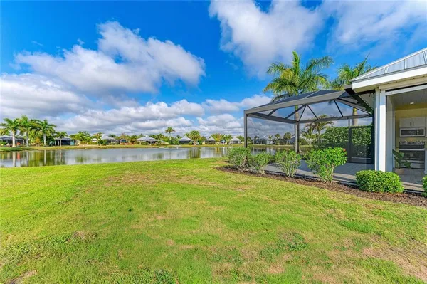 a view of a patio with a table and chairs under an umbrella