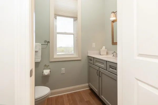 a white toilet sitting next to a bathroom sink