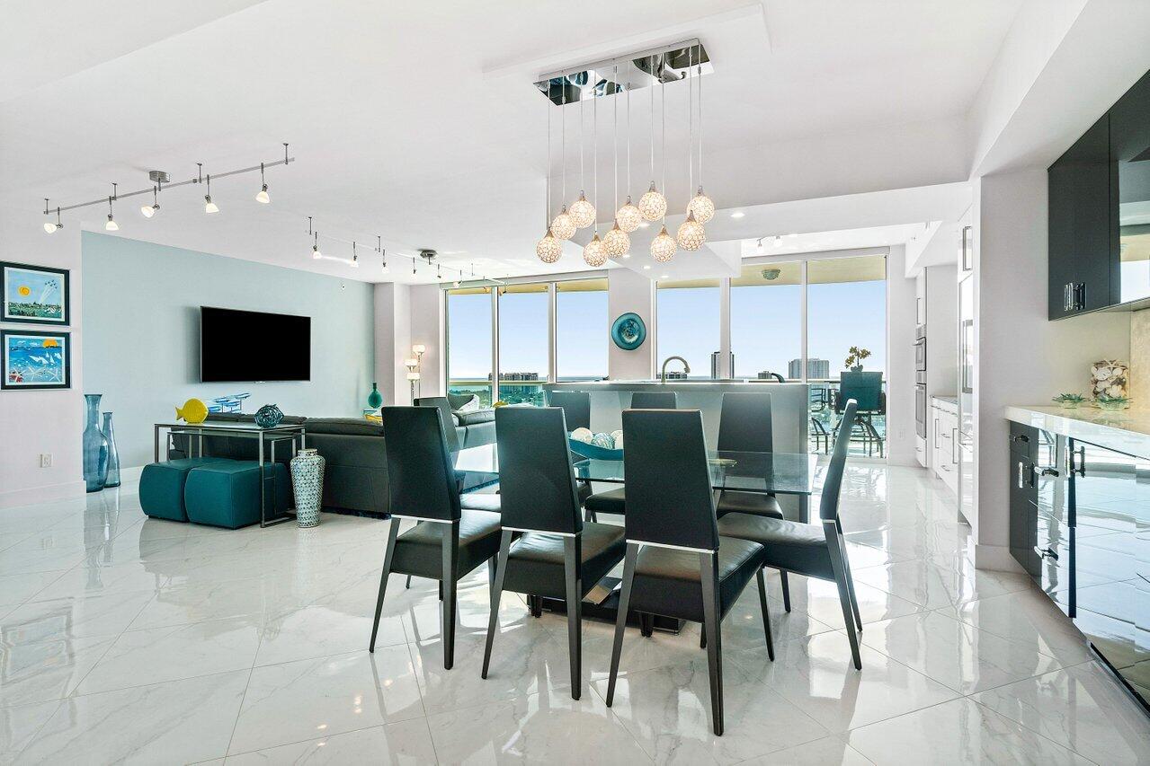 2640 Lake Shore Drive, Unit 2307 Riviera Beach, FL 33404 - Photo 13 of 64 a view of a dining room with furniture and chandelier