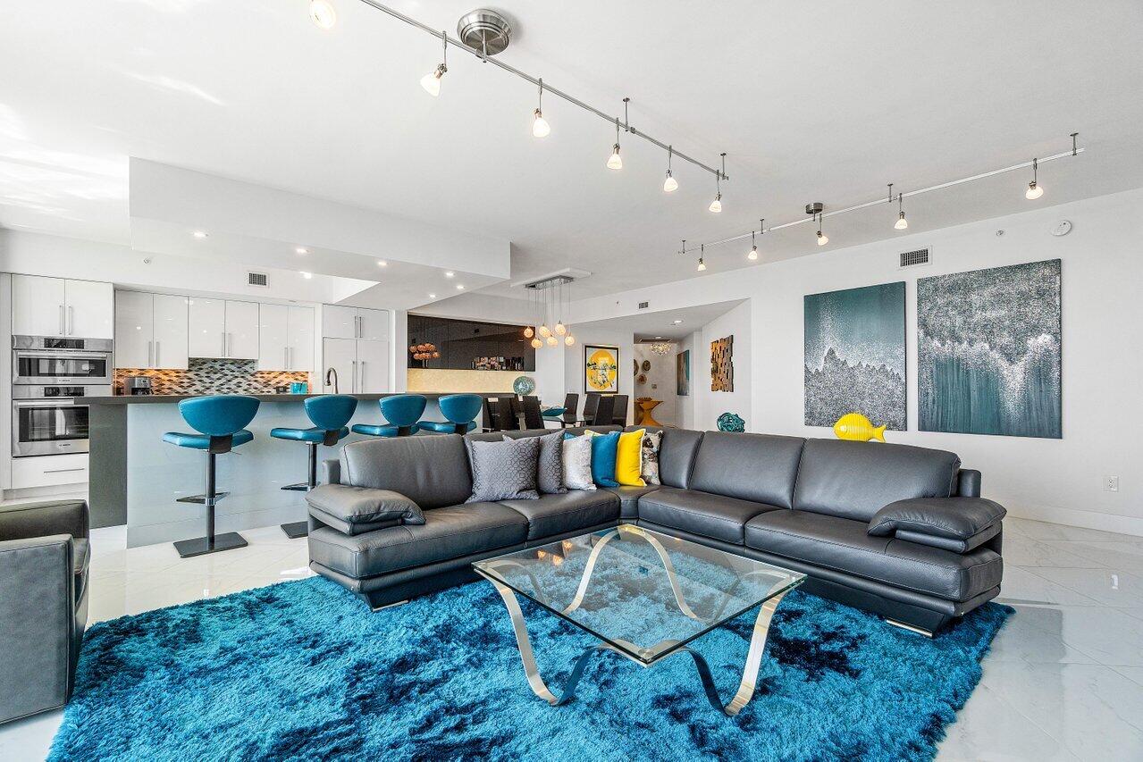 2640 Lake Shore Drive, Unit 2307 Riviera Beach, FL 33404 - Photo 16 of 64 a living room with furniture and kitchen view