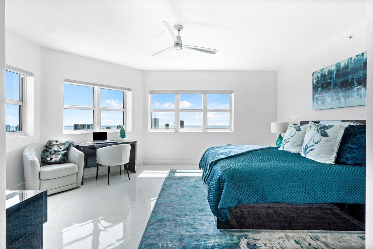 2640 Lake Shore Drive, Unit 2307 Riviera Beach, FL 33404 - Photo 21 of 64 a bedroom with a bed and a couch