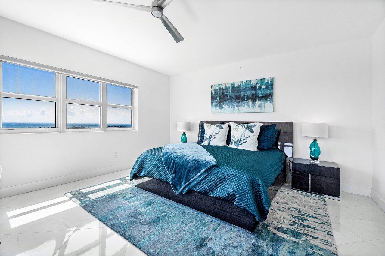 2640 Lake Shore Drive, Unit 2307 Riviera Beach, FL 33404 - Photo 23 of 64 a bedroom with a bed and wooden floor