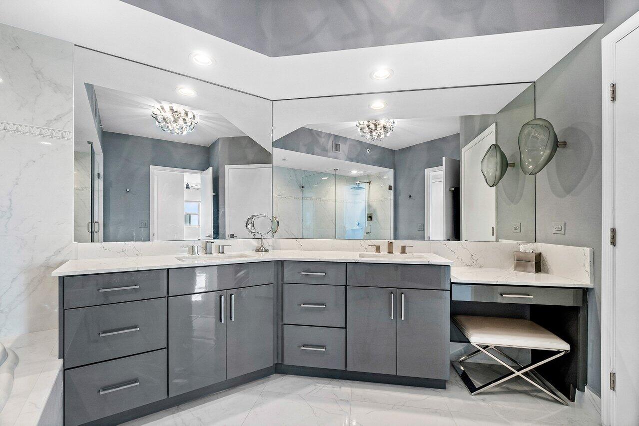 2640 Lake Shore Drive, Unit 2307 Riviera Beach, FL 33404 - Photo 28 of 64 a spacious bathroom with a double vanity sink and a mirror