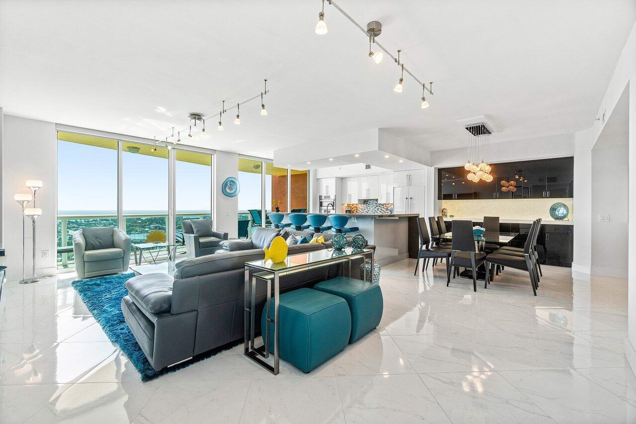 2640 Lake Shore Drive, Unit 2307 Riviera Beach, FL 33404 - Photo 5 of 64 a living room with lots of furniture and a large window