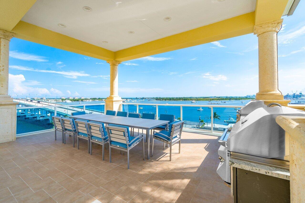 2640 Lake Shore Drive, Unit 2307 Riviera Beach, FL 33404 - Photo 51 of 64 a view of a patio with a table and chairs