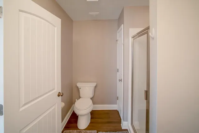 a bathroom with a toilet and a shower