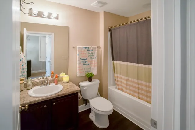 a bathroom with a sink toilet and shower
