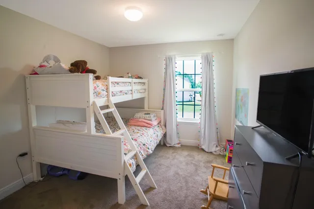 a bedroom with furniture and a window