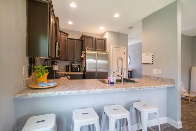 a kitchen with cabinets a sink and appliances