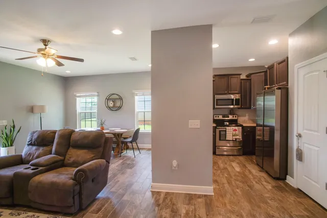 a living room with furniture and a wooden floor