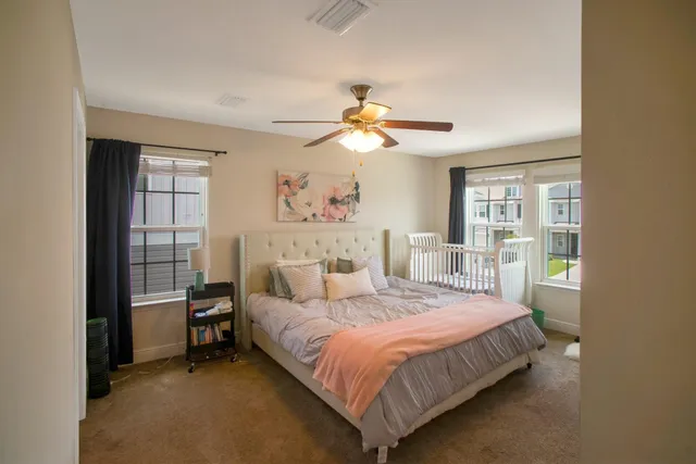 a bedroom with a bed and a window