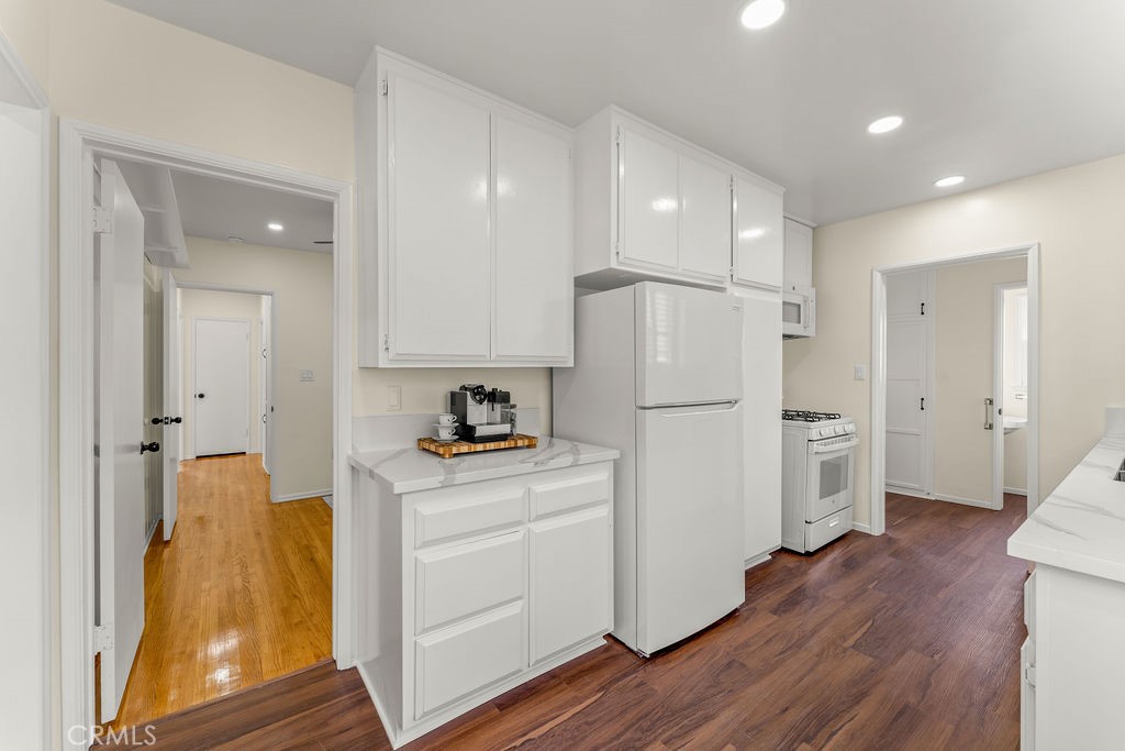 14622 Danbrook Drive Whittier, CA 90604 - Photo 14 of 38 a kitchen with a refrigerator a stove top oven and wooden floor
