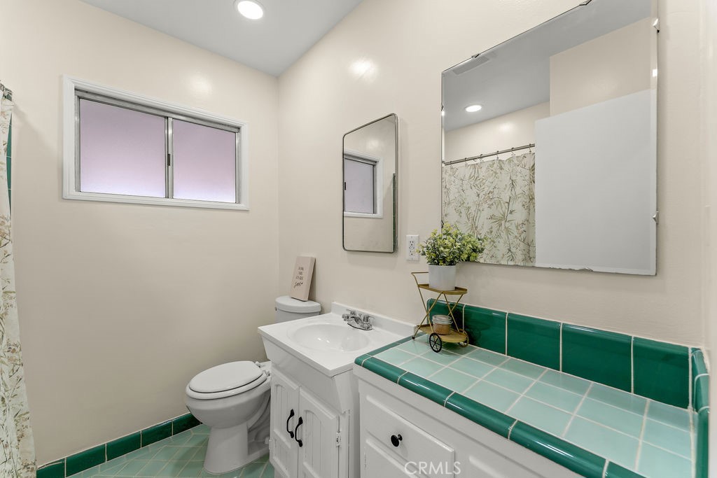 14622 Danbrook Drive Whittier, CA 90604 - Photo 24 of 38 a bathroom with a sink a toilet and mirror