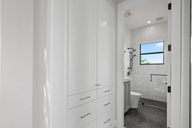 a view of a livingroom with furniture flat screen tv and windows