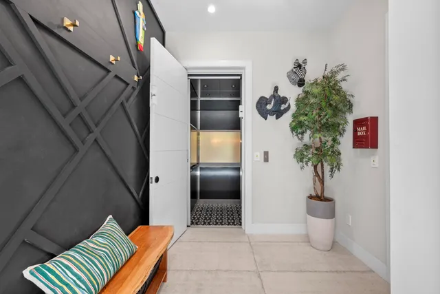 a living room with furniture and a floor to ceiling window